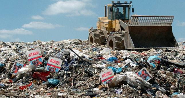 Bulldozer on a landfill strewn with Atari game boxes, the 1983 video game crash that analysts called the end of gaming